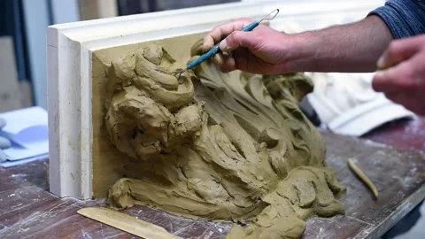 Sculptor create clay model of a Corinthian capitel with acanthus leaves Stock Footage 132212498