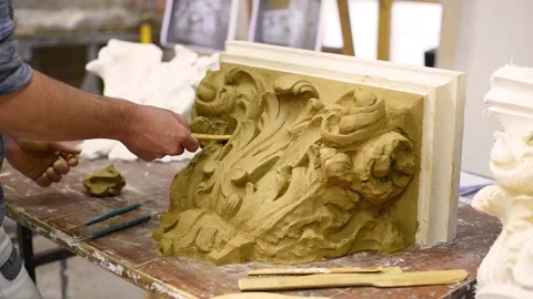 Sculptor create clay model of a Corinthian capitel with acanthus leaves Stock Footage 132212714
