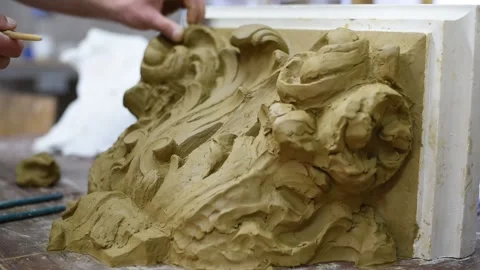 Sculptor create clay model of a Corinthian capitel with acanthus leaves Stock Footage 132212731