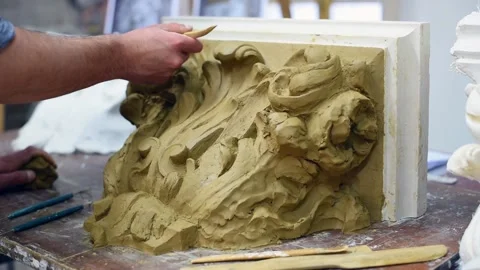 Sculptor create clay model of a Corinthian capitel with acanthus leaves Stock Footage 132212761