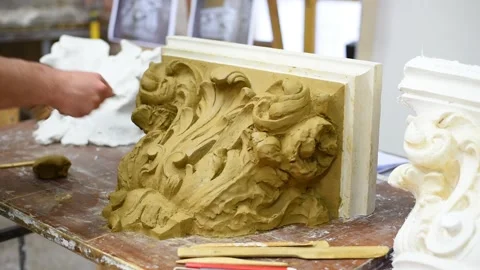 Sculptor create clay model of a Corinthian capitel with acanthus leaves Stock Footage 132213076