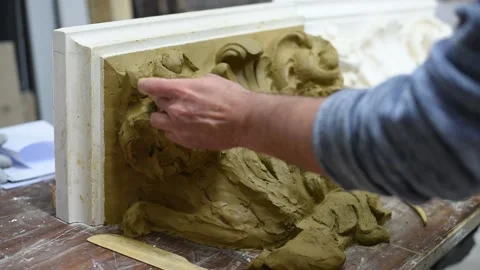 Sculptor create clay model of a Corinthian capitel with acanthus leaves Stock Footage 132213124