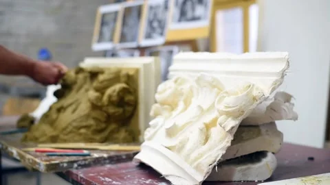 Sculptor create clay model of a Corinthian capitel with acanthus leaves Stock Footage 132213588