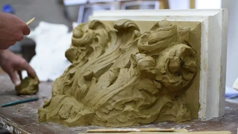Sculptor create clay model of a Corinthian capitel with acanthus leaves Stock Footage 132213593