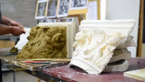 Sculptor create clay model of a Corinthian capitel with acanthus leaves Stock Footage 132213612