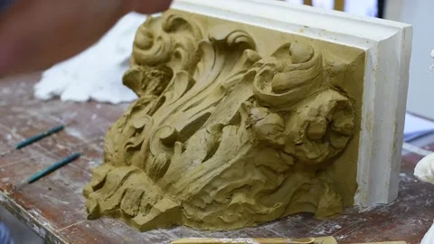 Sculptor create clay model of a Corinthian capitel with acanthus leaves Stock Footage 132213881