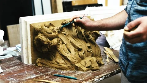 Sculptor create clay model of a Corinthian capitel with acanthus leaves Stock Footage 132214096