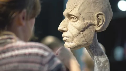 Sculptor creating sculpture of man's head. Woman working in studio. Nose Stock Footage 152132053