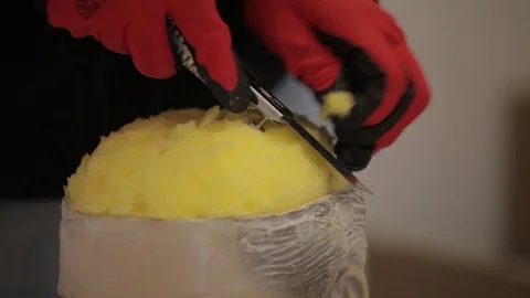 The sculptor cuts the sponge which is in the doll's head Stock Footage 86820541