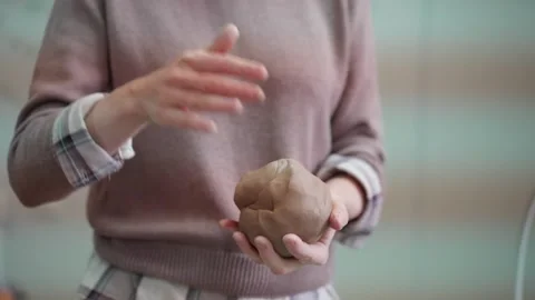 The sculptor forms a piece of clay with his hands. Stock Footage 148984271