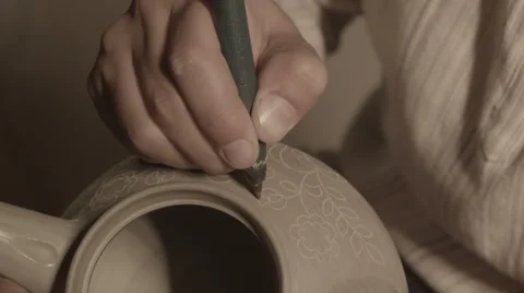 Sculptor Master Sculpt Pattern on Ceramic teapot Video stock 68113686