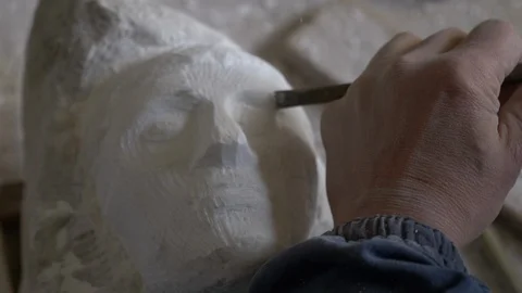 Sculptor models a marble statue with an electric scalpel 動画素材 119425486