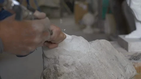 Sculptor models a statue face with an electric scalpel 動画素材 119427320