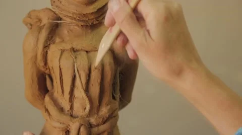 Sculptor Uses Tool To Sculpt Side Of Statue , Clay Stock Footage 41992609