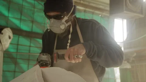 Sculptor working with an angle grinder and making a sculpture Stock Footage 274998634