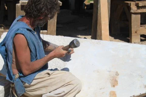 Sculptor working block of stone Stock Photos