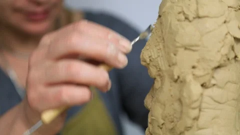 Sculptor is working on the creation of a man's face closeup. Stock Footage 90868182