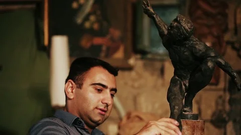 Sculptor working on a monument made of clay Stock Footage 81522677