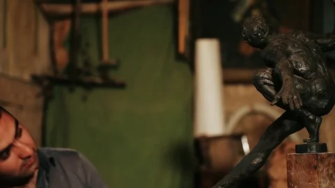 Sculptor working on a monument made of clay Stock Footage 81522692