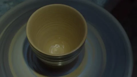 A sculptor in a workshop makes a clay jug close up. Man's hand making a clay jug Stock Footage 130196793