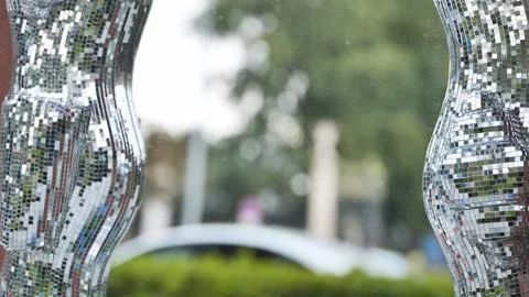 Sculptural elements reflecting light in a park environment Stock Photos