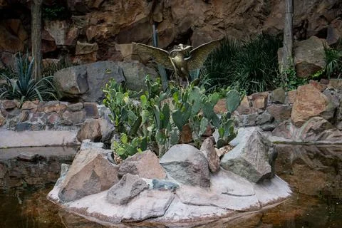 Sculpture of the eagle devouring a snake on top of a cactus Stock Photos
