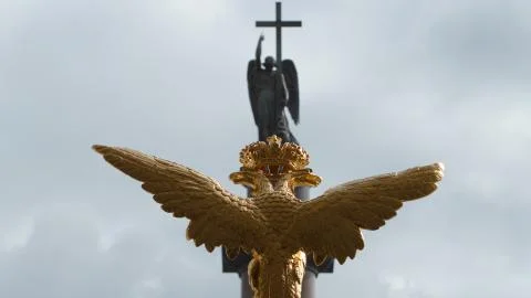 Sculpture of golden two-headed eagle and the angel on the Alexander Column on Stock Photos