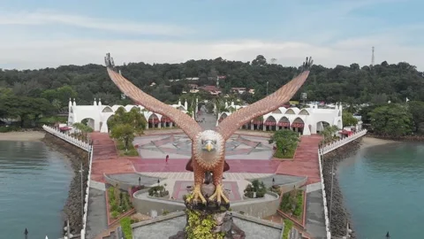 A sculpture of a huge red-winged eagle. Popular tourist photo point on Langkawi  Stock Footage 139874385