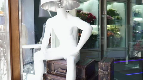 Sculpture of a man with a lamp instead of a head in a shop window Stock Footage 197482410