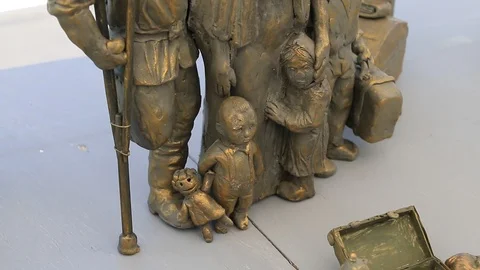 Sculpture of a migrant family Stock Footage