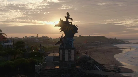 Sculpture on the ocean in the warm rays of dawn. Bali, Indonesia Stock Footage 112736352