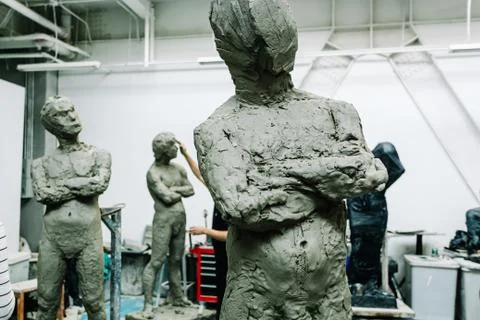Sculptures of men in a working studio 스톡 사진