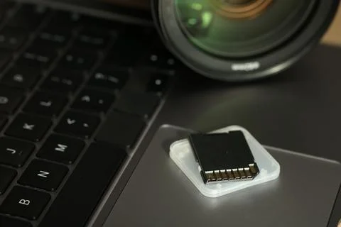 SD memory card, holder and photo camera on laptop, closeup Stock Photos