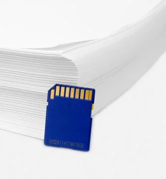 Sd memory card with a stack of printer paper. hardcopy backup or go paperless Stock Photos