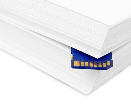 Sd memory card with a stack of printer paper. hardcopy backup or go paperless Stock Photos