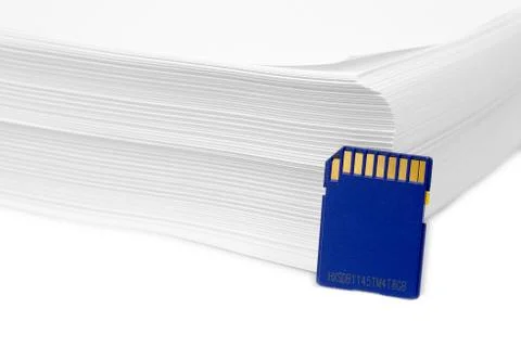 Sd memory card with a stack of printer paper. hardcopy backup or go paperless Stock Photos