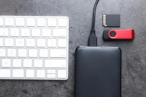 SD memory card, USB flash drive, hard disk drive with cable and keyboard on.. Stock Photos