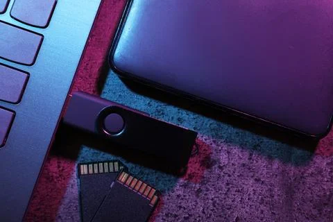 SD memory cards, USB flash drive, hard disk drive and laptop on dark grey t.. Stock Photos