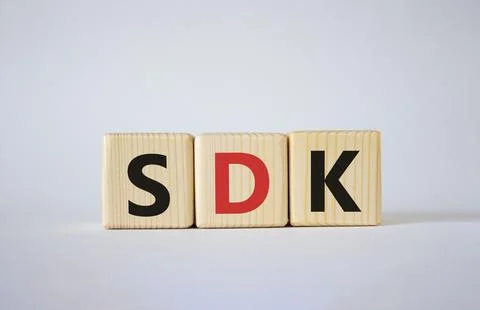 SDK - software development kit. Wooden cubes with word SDK . Beautiful whit.. 스톡 사진