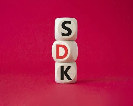 SDK - software development kit. Wooden cubes with word SDK . Beautiful red .. Stock Photos