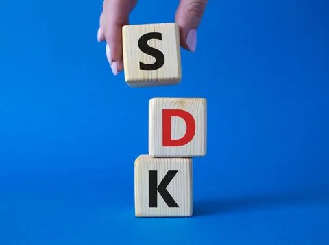 SDK - software development kit. Wooden cubes with word SDK . Businessman ha.. Foto stock