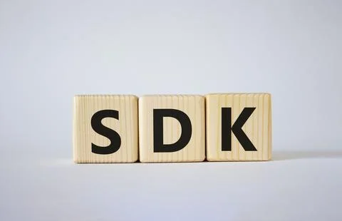 SDK - software development kit. Wooden cubes with word SDK . Beautiful whit.. Stock Photos