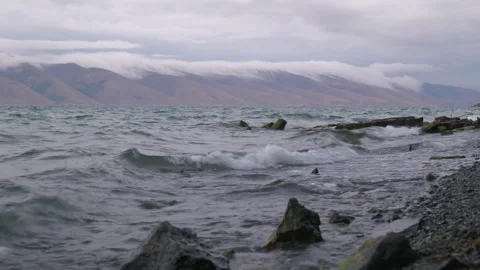 Sea against the backdrop of mountains in the clouds Video stock 252122191