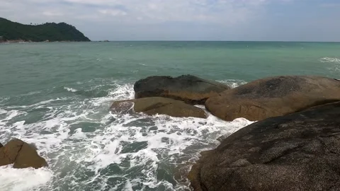 The sea is agitated and the waves break on the rocks. Stock Footage 230079155