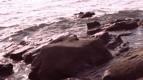 Sea among the rocks at sunset Видео 259063872