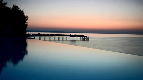 Sea and infinite pool view during sunrise timelapse Video stock 70453114