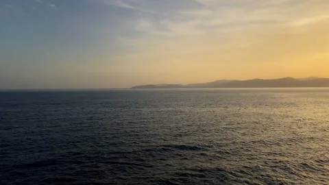 Sea and a lighthouse on a cliff at sunset Stock Footage 251795438