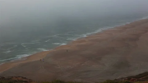 Sea and sandy beach in dense fog, autumn day Stock Footage 122563470