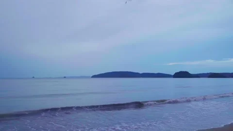 The sea and the sandy beach in the evening on a rainy day See the mountain range Stock Footage 232288009