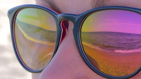 The sea and the sky are reflected in the sunglasses Stock Footage 92786843
